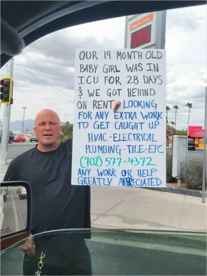 Man holding sign seeking work, life struggles impacting today's lost generation.