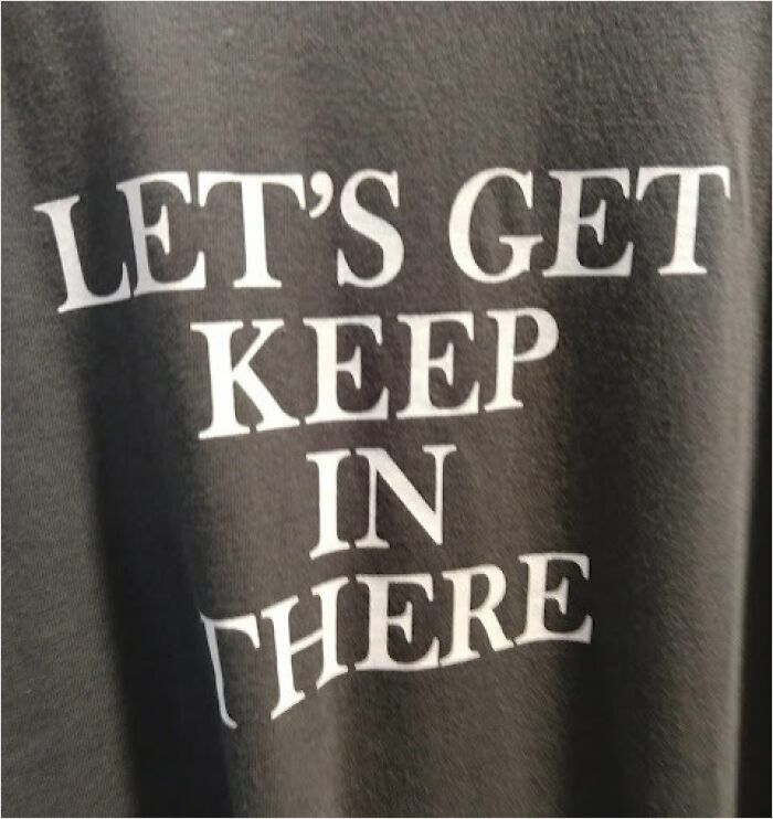 Funny translation on shirt in Japan: "LET'S GET KEEP IN THERE" in white text.