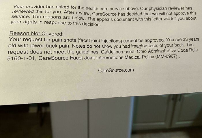 Insurance denial letter citing guidelines for pain treatment, reflecting a boring dystopia scenario.