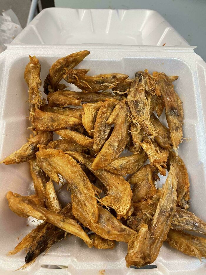 Unhinged food: a container of dried fish ready to eat.