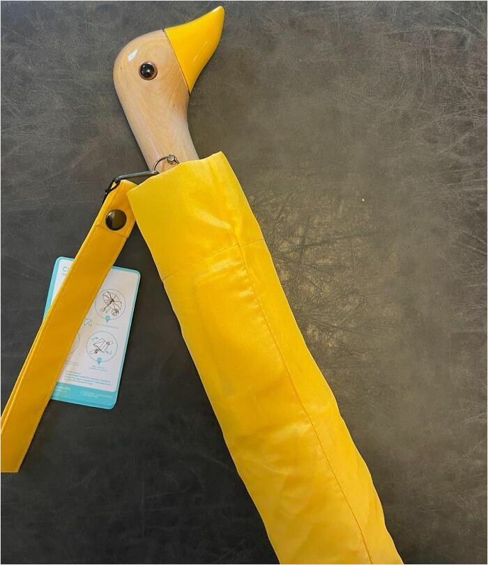 Yellow duck-handled umbrella, an object we covet.