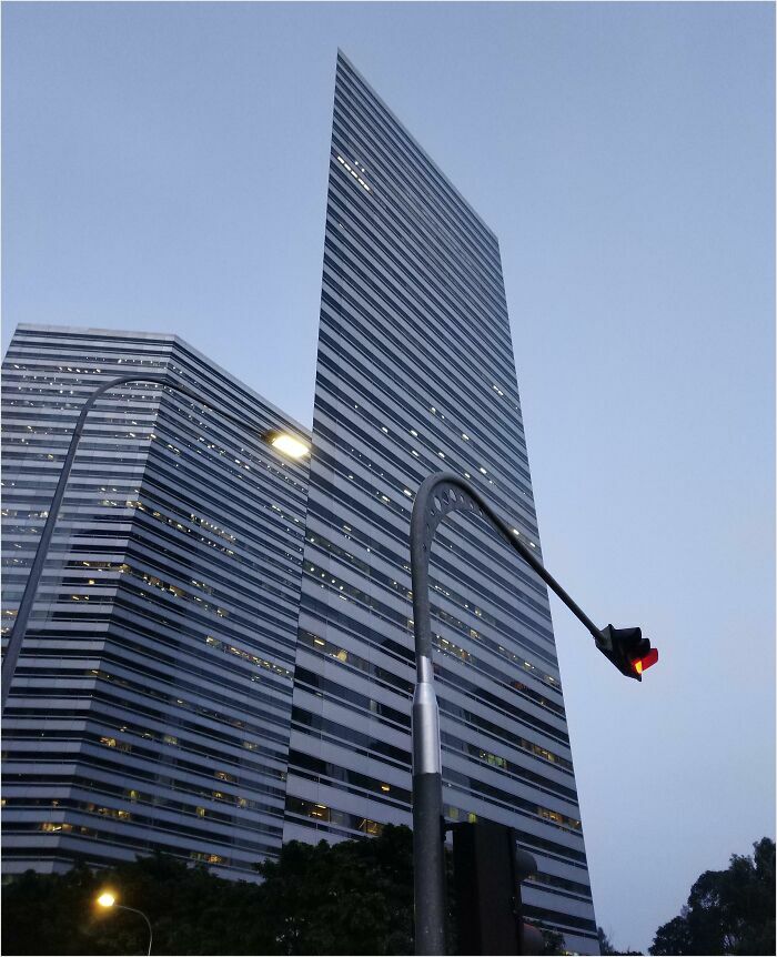 Modern skyscraper in daylight with geometric designs resembling bad renders.