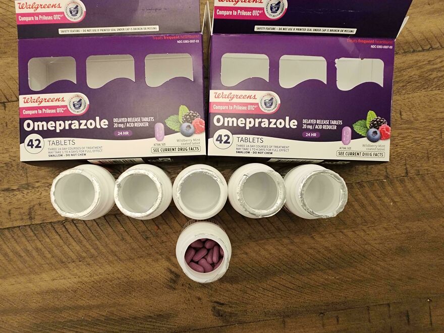 Unnecessary packaging of omeprazole with multiple empty bottles and two empty boxes.