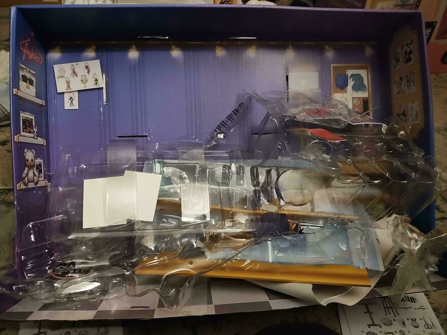 Excessive plastic and cardboard packaging inside a toy box, highlighting the issue of wasteful and unnecessary materials used.