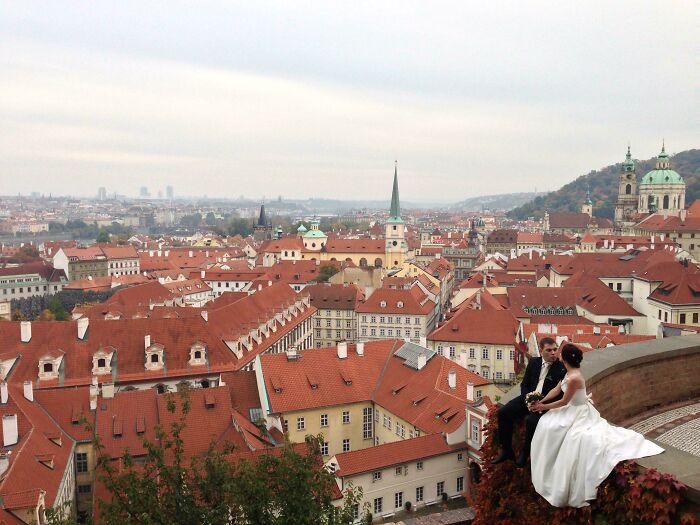 Bride and groom overlooking cityscape with red rooftops, exemplifying incredible world photos.