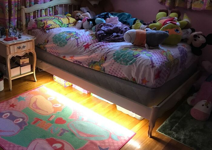 Cozy Reddit room upgrade with colorful bedding and plush toys, featuring animated character-themed decor.