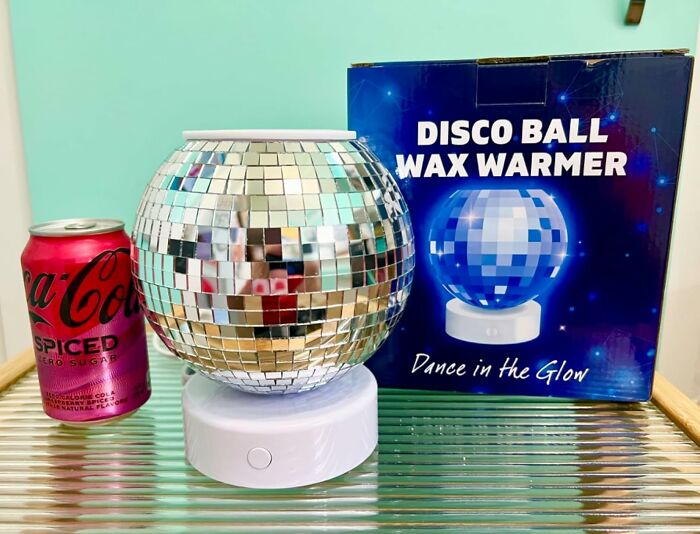 Disco ball wax warmer, ideal gift for antisocial people, next to a can of spiced Coca-Cola Zero Sugar.