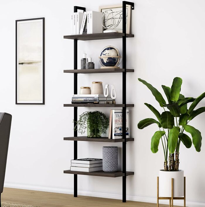 Modern shelving unit from Amazon with excellent reviews, featuring books and decor items next to a potted plant.