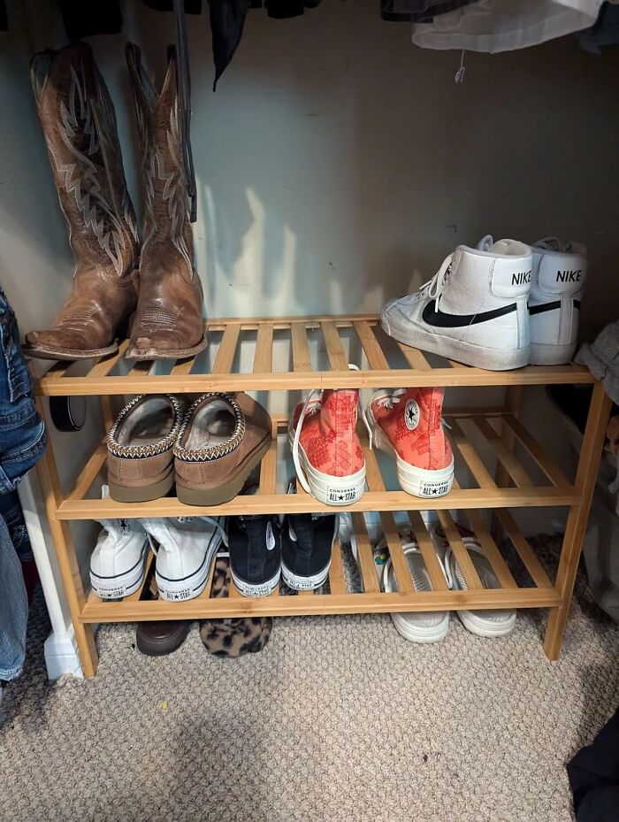 Wooden shoe rack from Amazon with excellent reviews, holding various shoes including boots and sneakers.