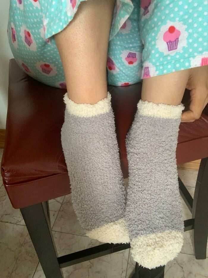 Cozy feet in fluffy socks and cupcake pajamas, linked to mom's viral "Brr Basket" video trend.