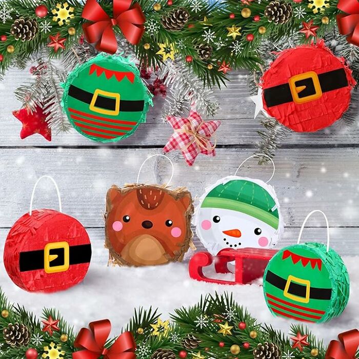 Festive holiday gift card holders shaped like Santa, elf, and snowman, surrounded by Christmas decorations.