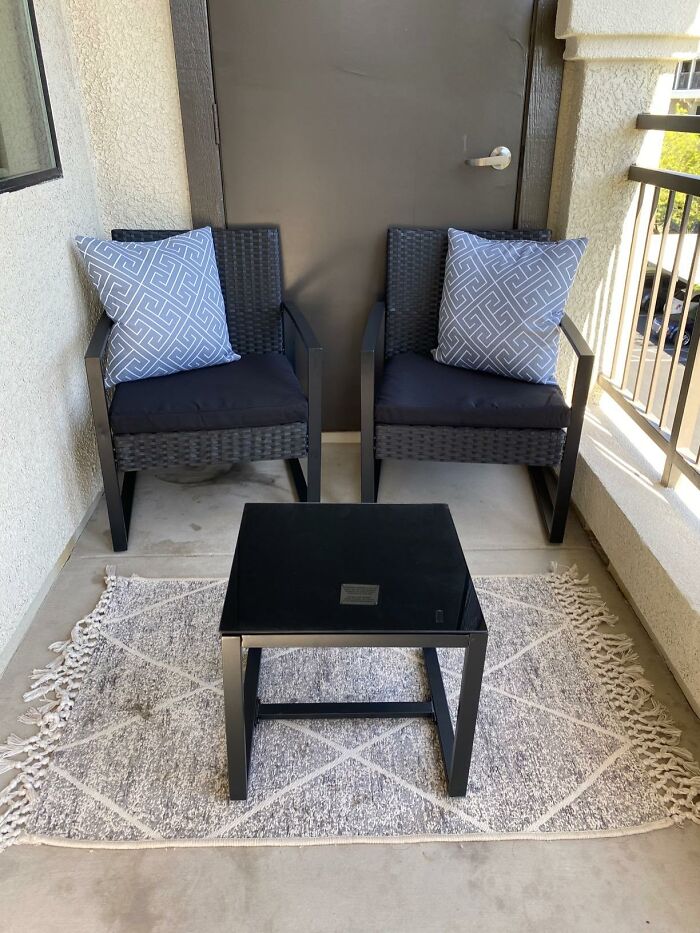 Two wicker chairs with patterned cushions and a glass-top table on a decorative rug, showcasing Amazon furniture.