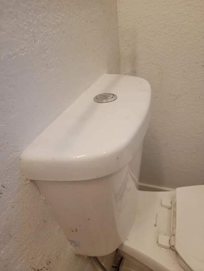 Toilet placed too close to the wall, a classic example of cheap construction fails.