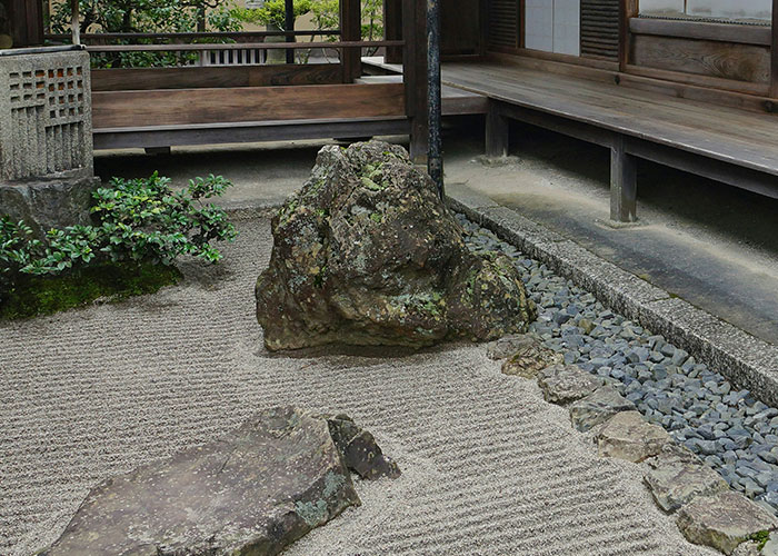 Zen garden with raked sand and rocks, evoking tranquility and leaving a mark in memory.