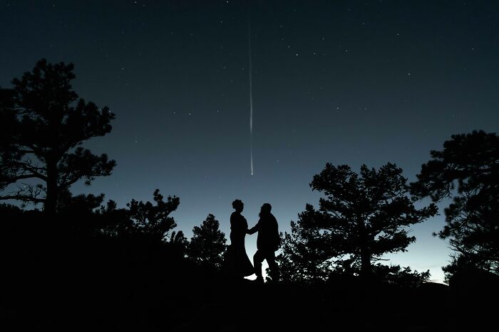 Silhouette of a couple under a shooting star, capturing a top wedding photo of 2024.