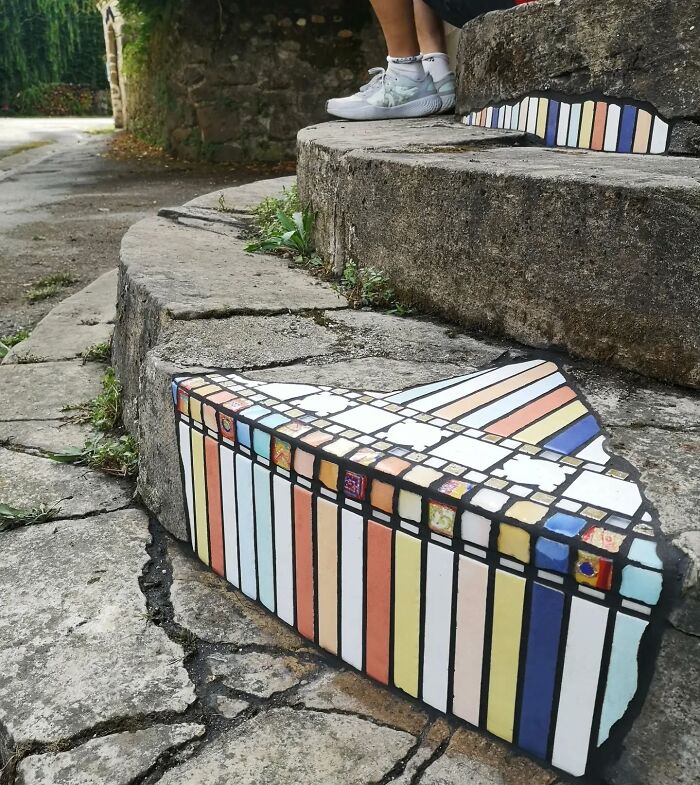 Vibrant mosaic art mending cracked sidewalk steps.