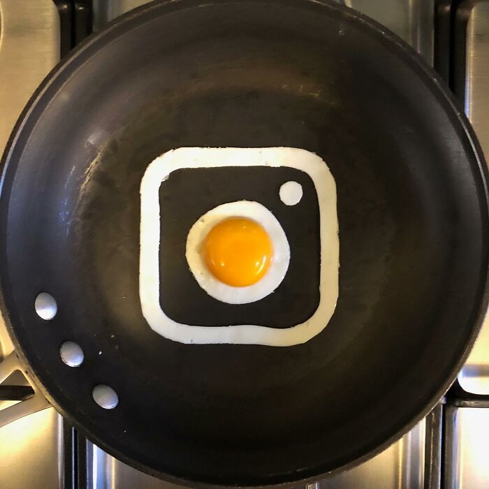 Creative egg fried in a pan shaped like Instagram logo.