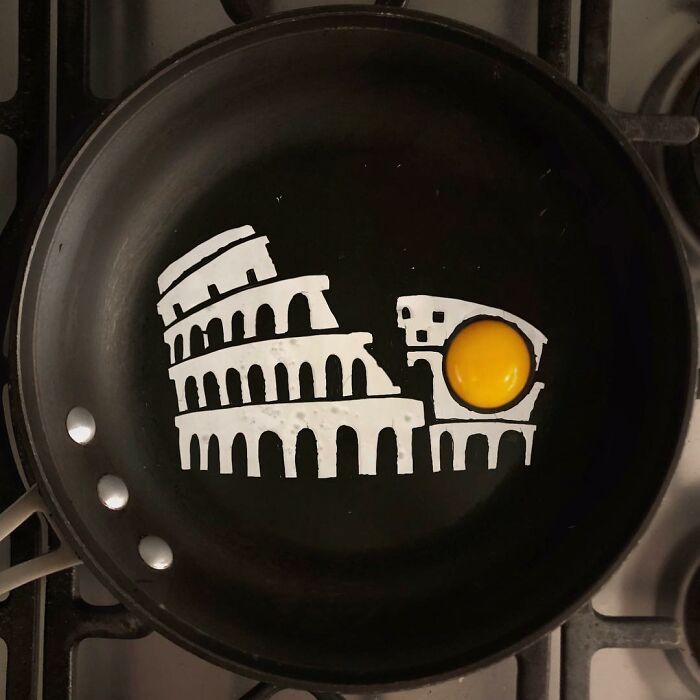 Creative fried egg art depicting the Leaning Tower of Pisa in a frying pan.