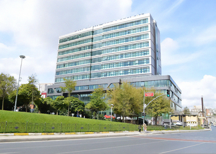 Exterior shot of Avrasya Hospital under a blue sky.