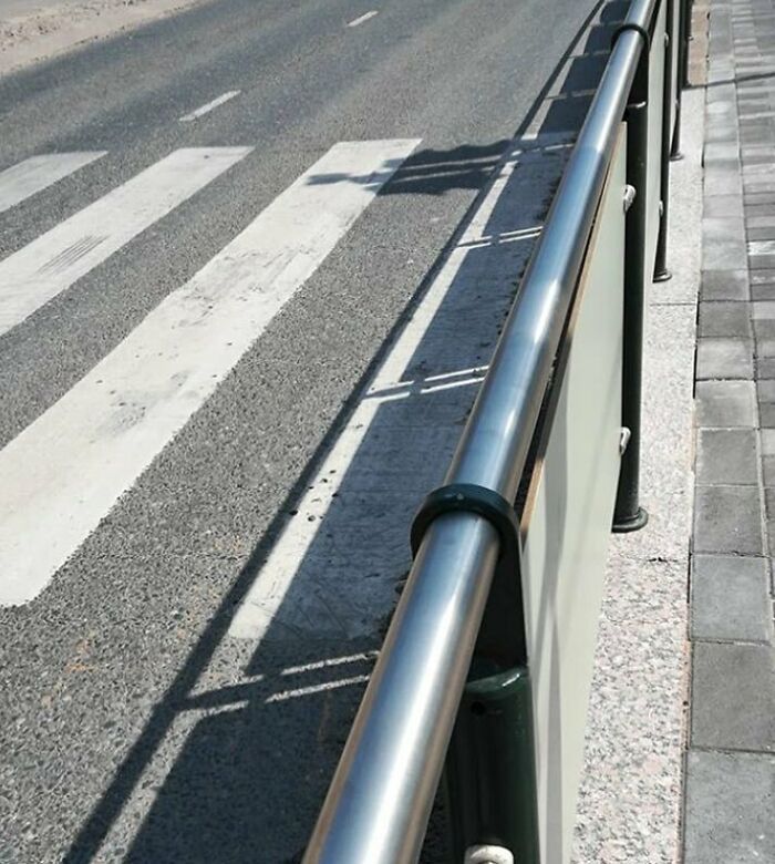 Construction fail: sidewalk railing blocks the crosswalk path.