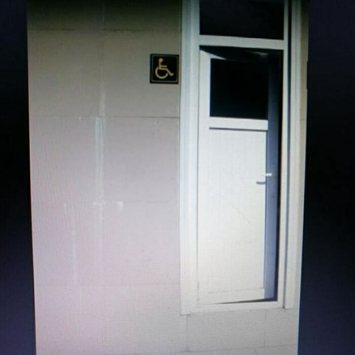 Construction fail: a misplaced door next to a wall with a wheelchair sign.