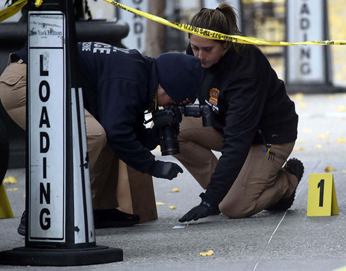 Forensic team investigating at crime scene related to Brian Thompson's homicide case.