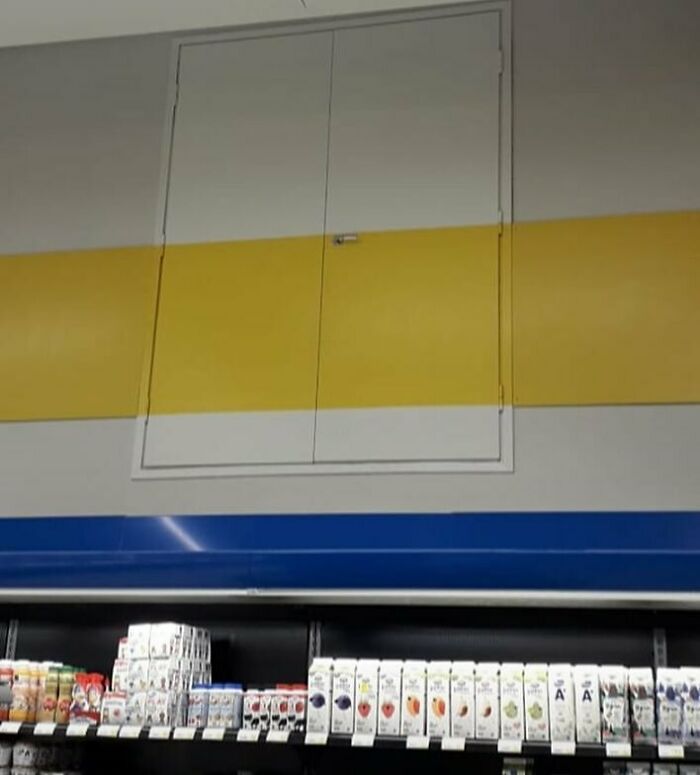 High wall storage cabinet with no access above grocery shelves; a classic construction fail.