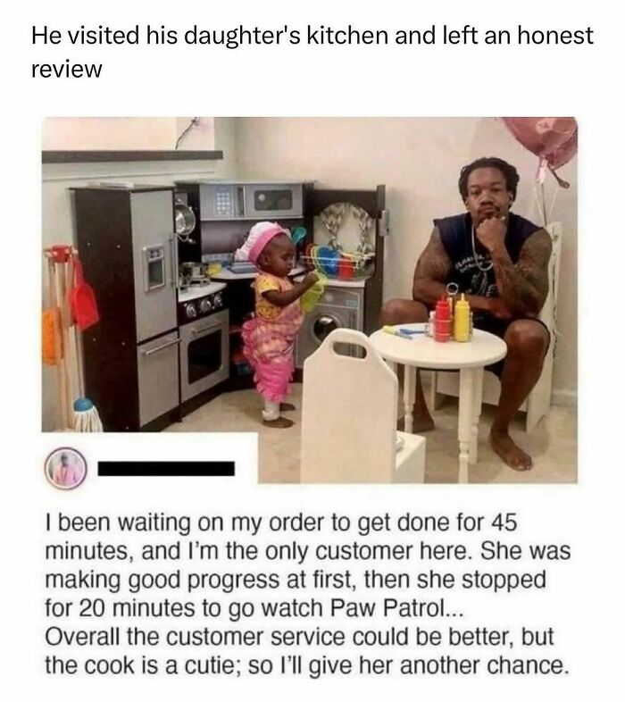 Father and daughter in a toy kitchen setup; wholesome kindness post about patience and humor in parenting.