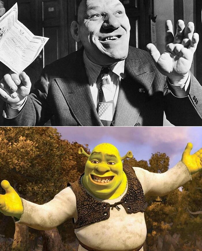 Black and white photo of a smiling man holding papers above an animation of a smiling green ogre; interesting history pic.