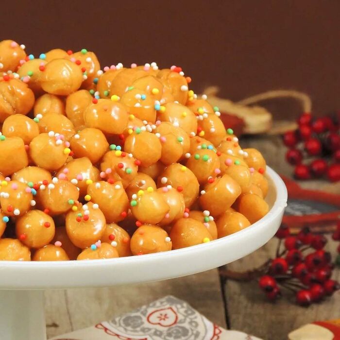 Plate of festive Christmas snack food topped with colorful sprinkles.