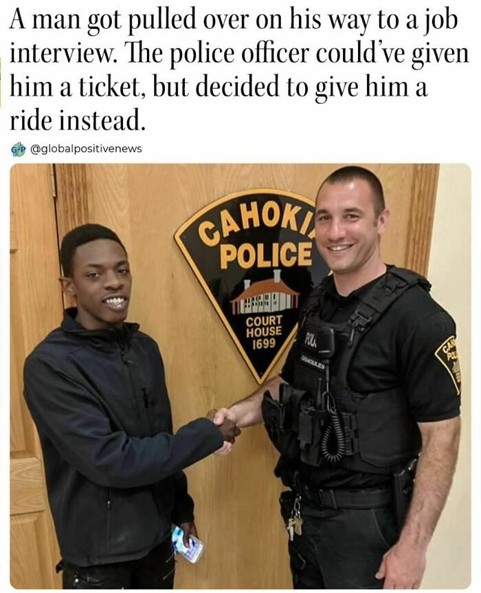 Man and police officer shaking hands in a wholesome kindness moment at a police department.