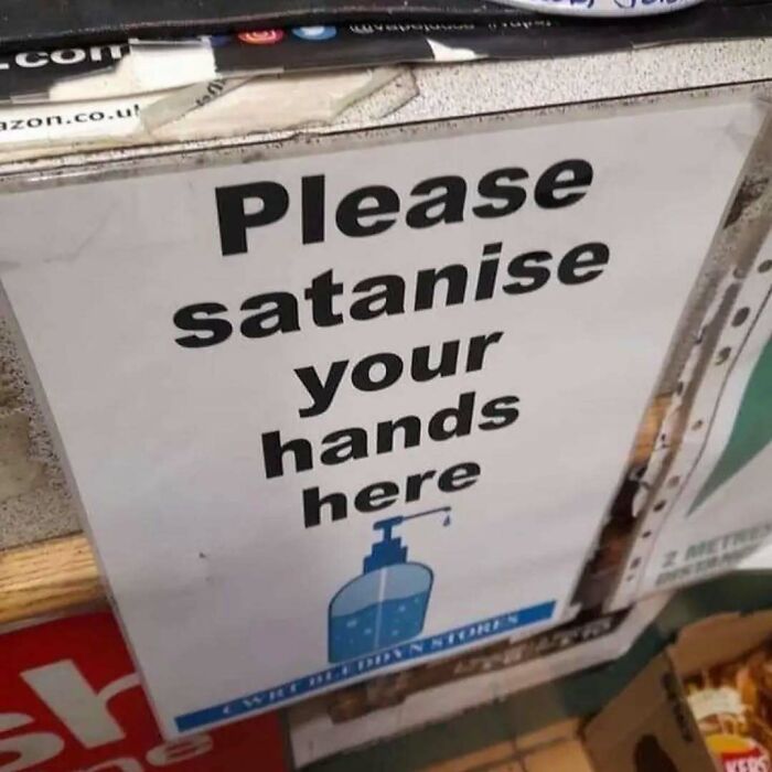 Sign with humorous typo: "Please satanise your hands here," showcasing relatable mental health meme humor.