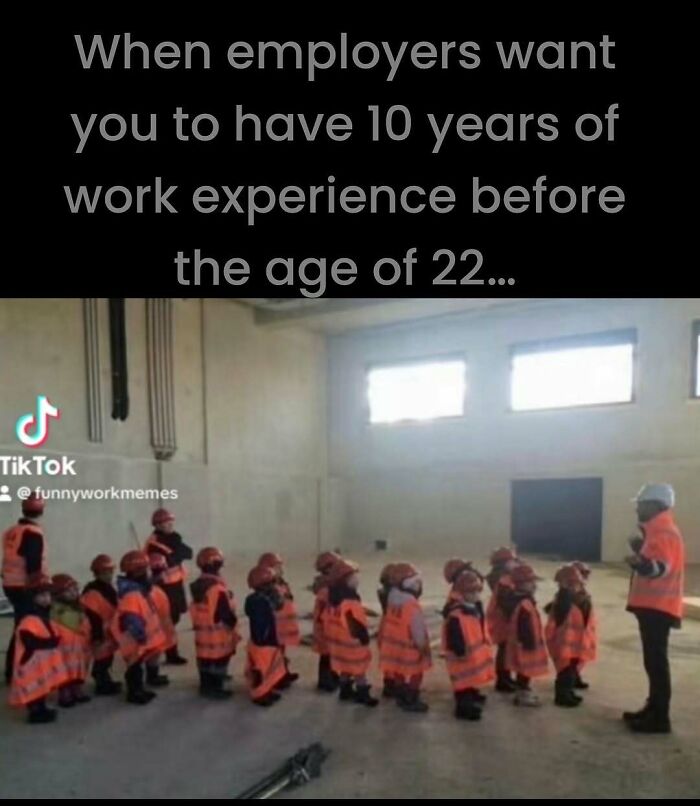 Children in hard hats and vests line up indoors like a work crew, humorously depicting unrealistic job experience demands.