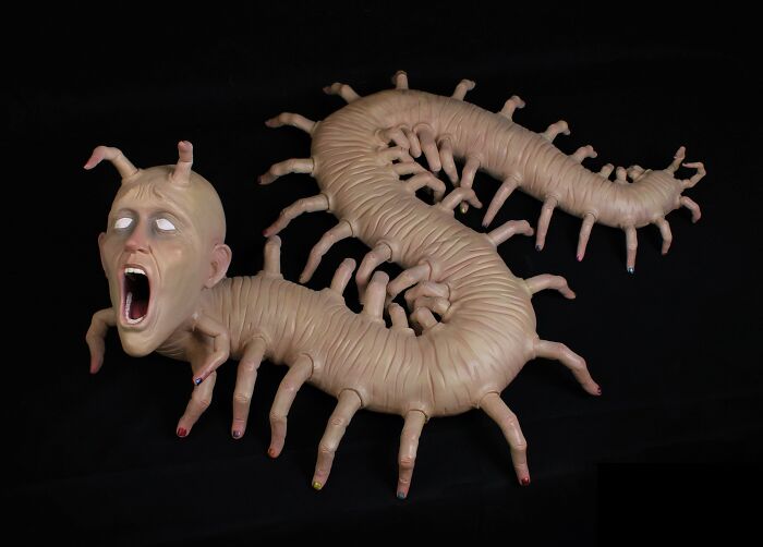 Surreal ceramic art depicting a centipede-like creature with a human face by Jackson Shaner.