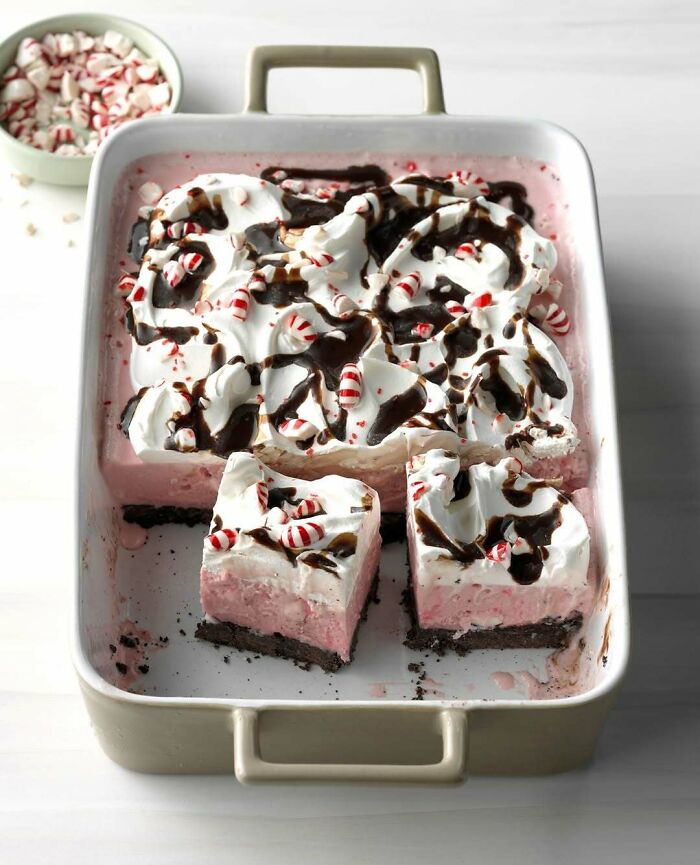 Christmas snack with chocolate drizzle and peppermint pieces in a baking dish.