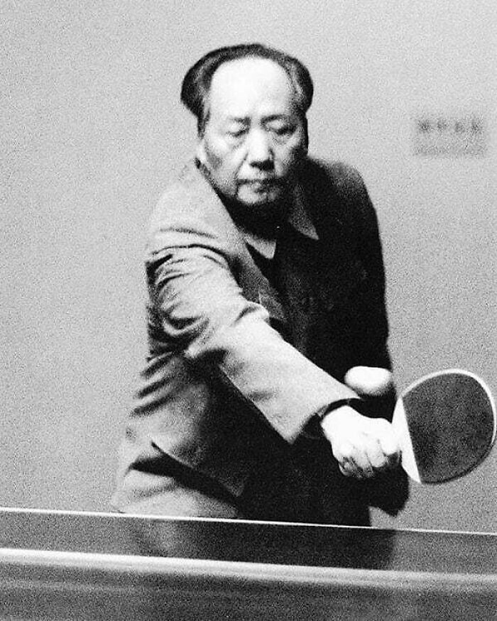 A historical figure playing table tennis, embodying lessons from the past to shape the future.