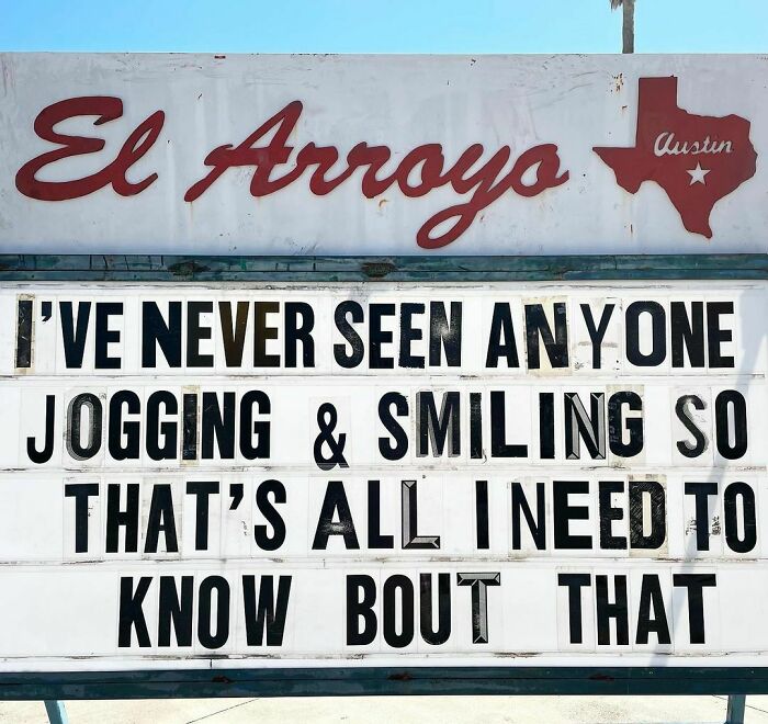 El Arroyo sign with a humorous message about jogging and smiling in Austin, Texas.