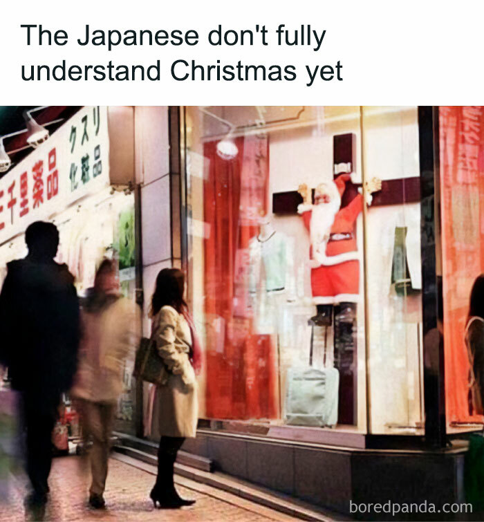 A Christmas meme featuring Santa on a cross in a Japanese store window display.