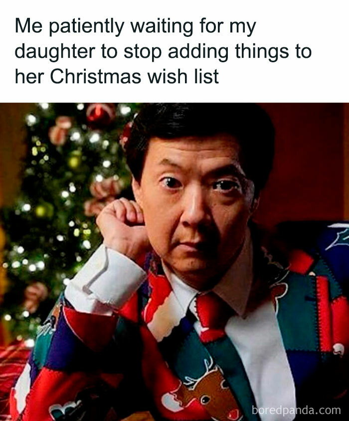 Man in a Christmas-themed suit looks amused in front of a decorated tree; funny Christmas memes capture holiday spirit.