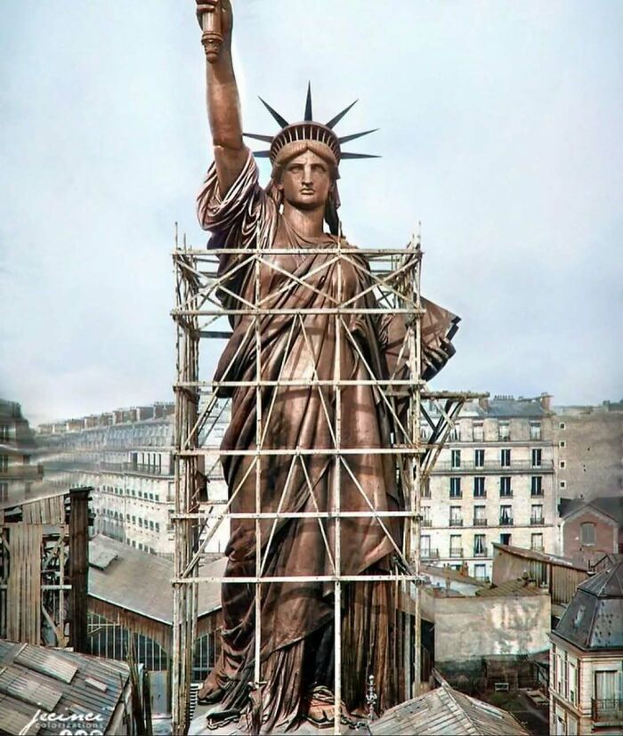 Statue of Liberty under construction, showcasing historical craftsmanship and architectural ingenuity.