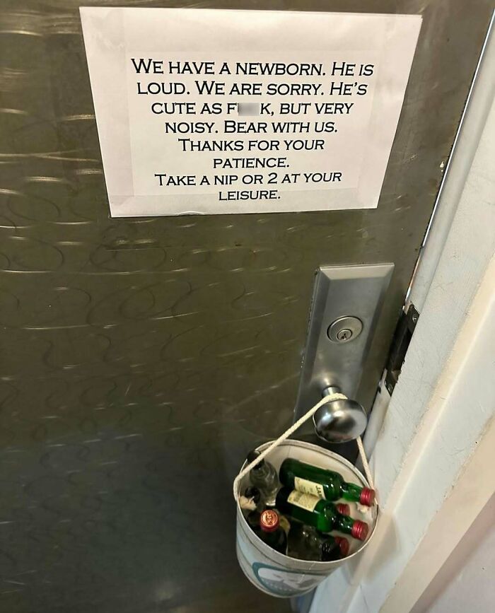 Note on a door in New York apologizing for newborn noise, offering drinks in a bucket as thanks for patience.