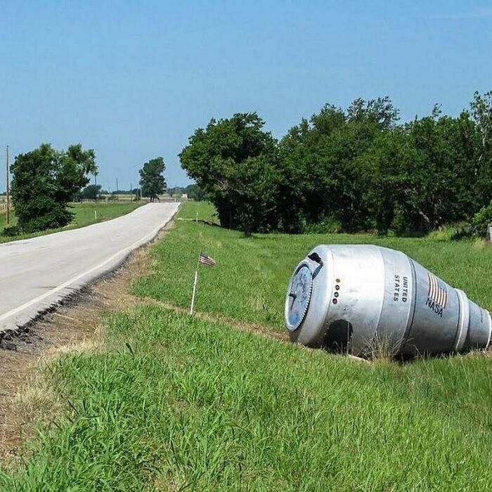 NASA space capsule replica by a rural roadside, capturing an interesting history pic.