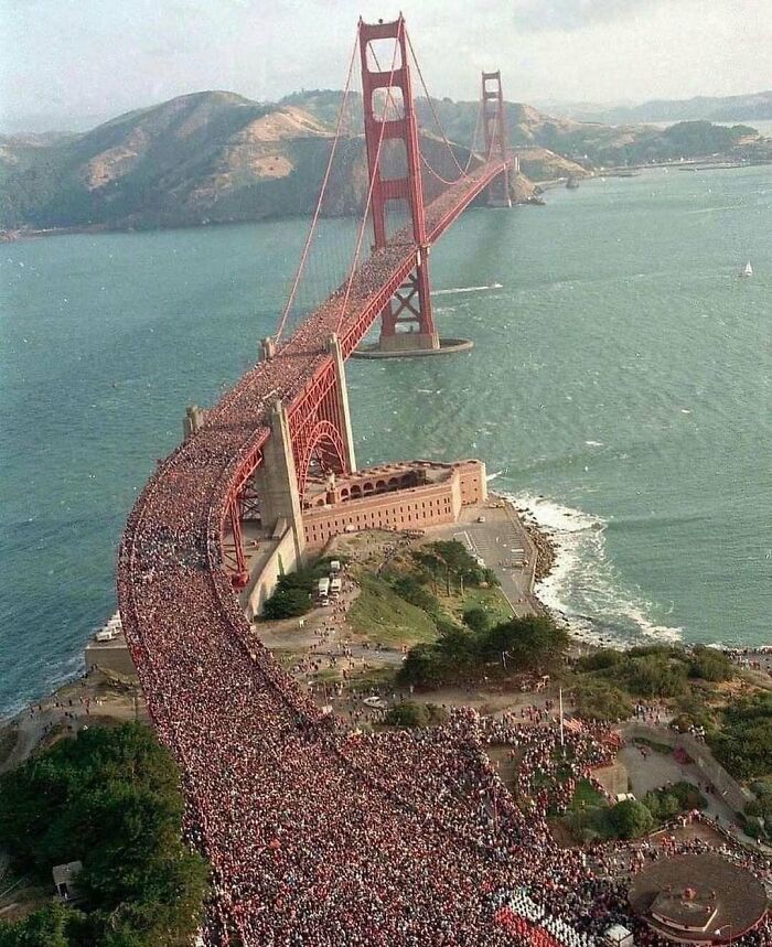 Crowds gathering on the Golden Gate Bridge, showcasing interesting history facts and iconic architecture.