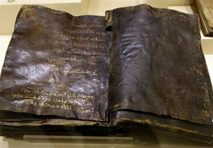 Ancient manuscript with interesting historical significance and mysterious text on dark parchment.