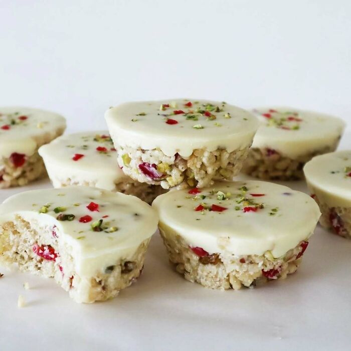 Christmas snack food featuring white chocolate-covered rice crispy treats with festive sprinkles.