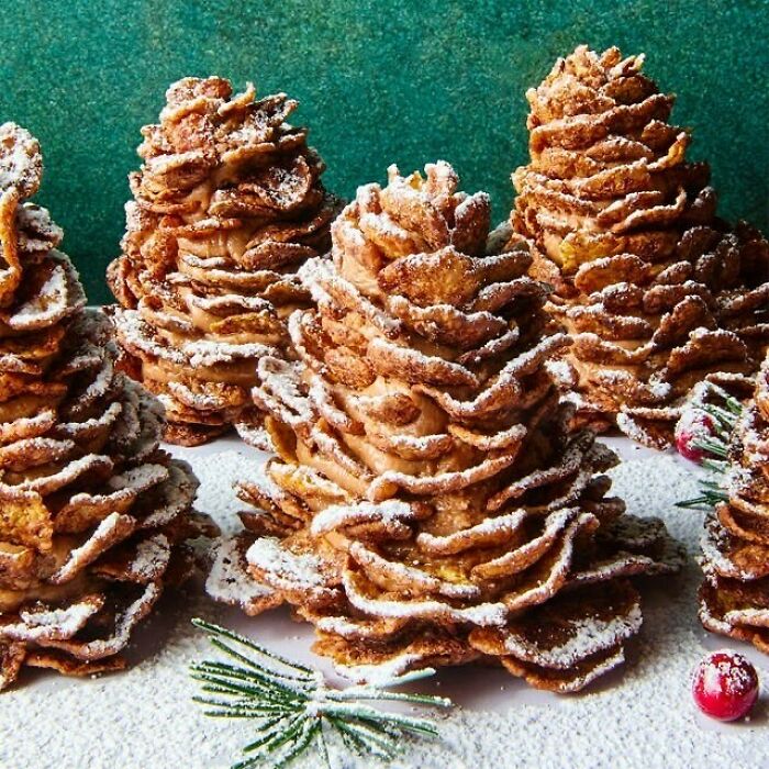 Christmas-themed snack trees made from crispy pastries dusted with powdered sugar.