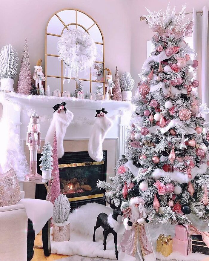 Christmas-decorating-ideas with a pink and white tree, ornaments, stockings on a mantel, and a festive fireplace scene.