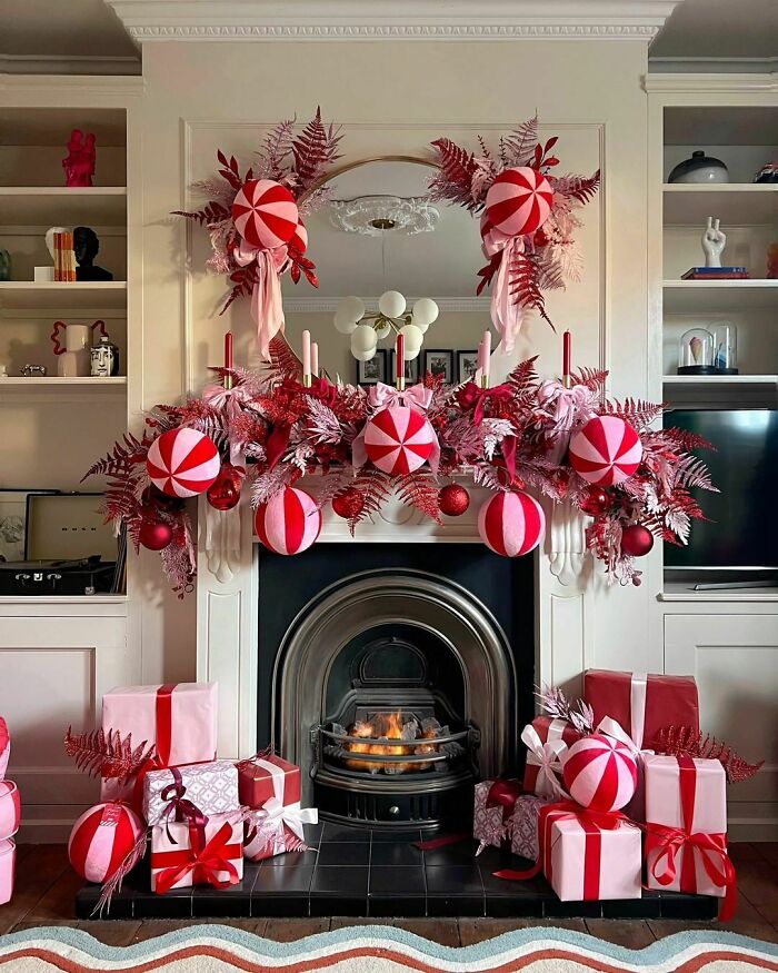 Festive fireplace with red and white Christmas decorations and gifts, highlighting creative Christmas-decorating-ideas.