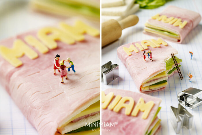 Miniature people on a ham sandwich with cheese letters, part of a creative duo's tiny world of foods.