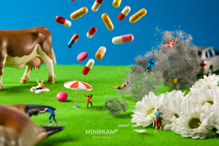 Miniature figures on a grassy landscape with a cow, umbrellas, flowers, and floating capsules depicting a tiny world of foods and things.